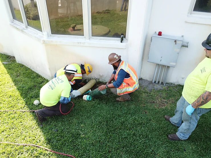 men repairing a pipe